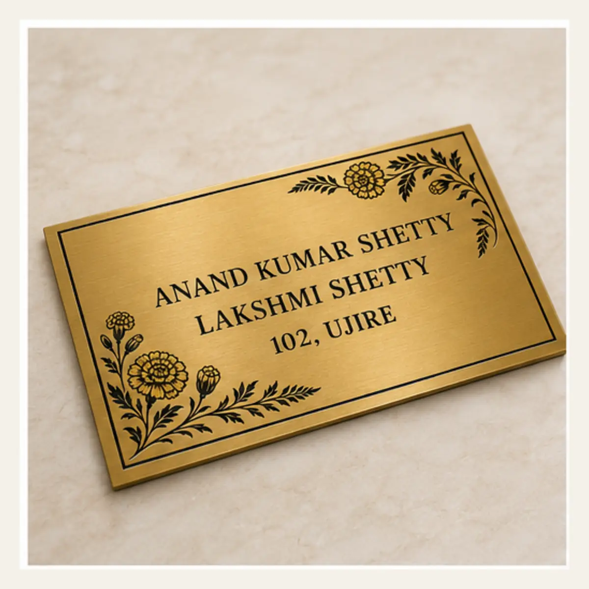 Angled product view of personalised botanical marigold brushed gold abs name plate with black engraving and 3M tape mounting