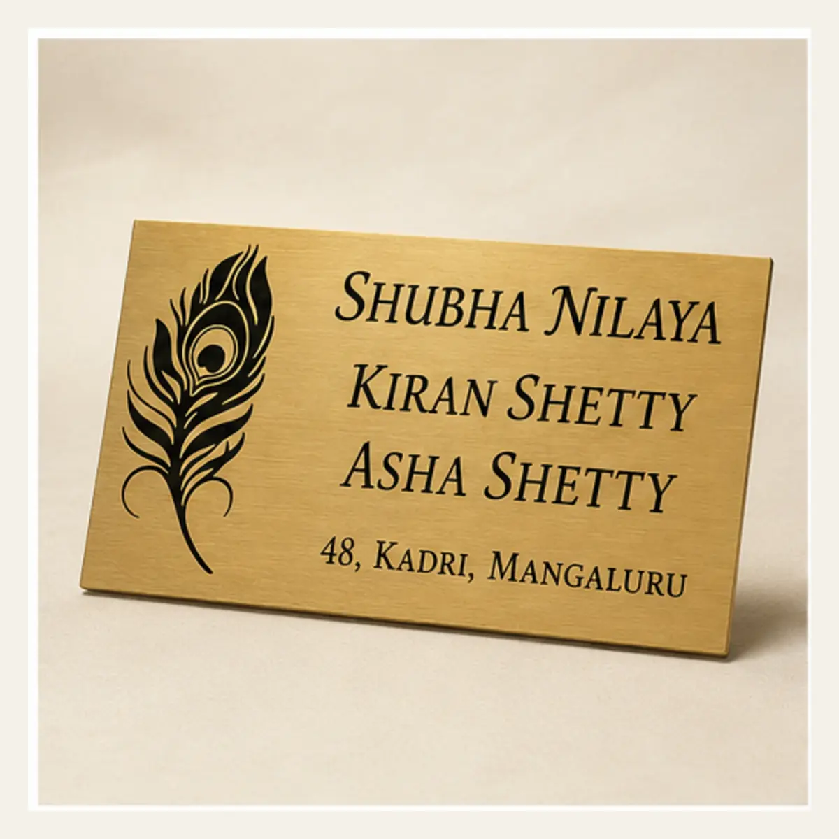Angled product view of personalised peacock feather family brushed gold abs name plate with black engraving and 3M tape mounting