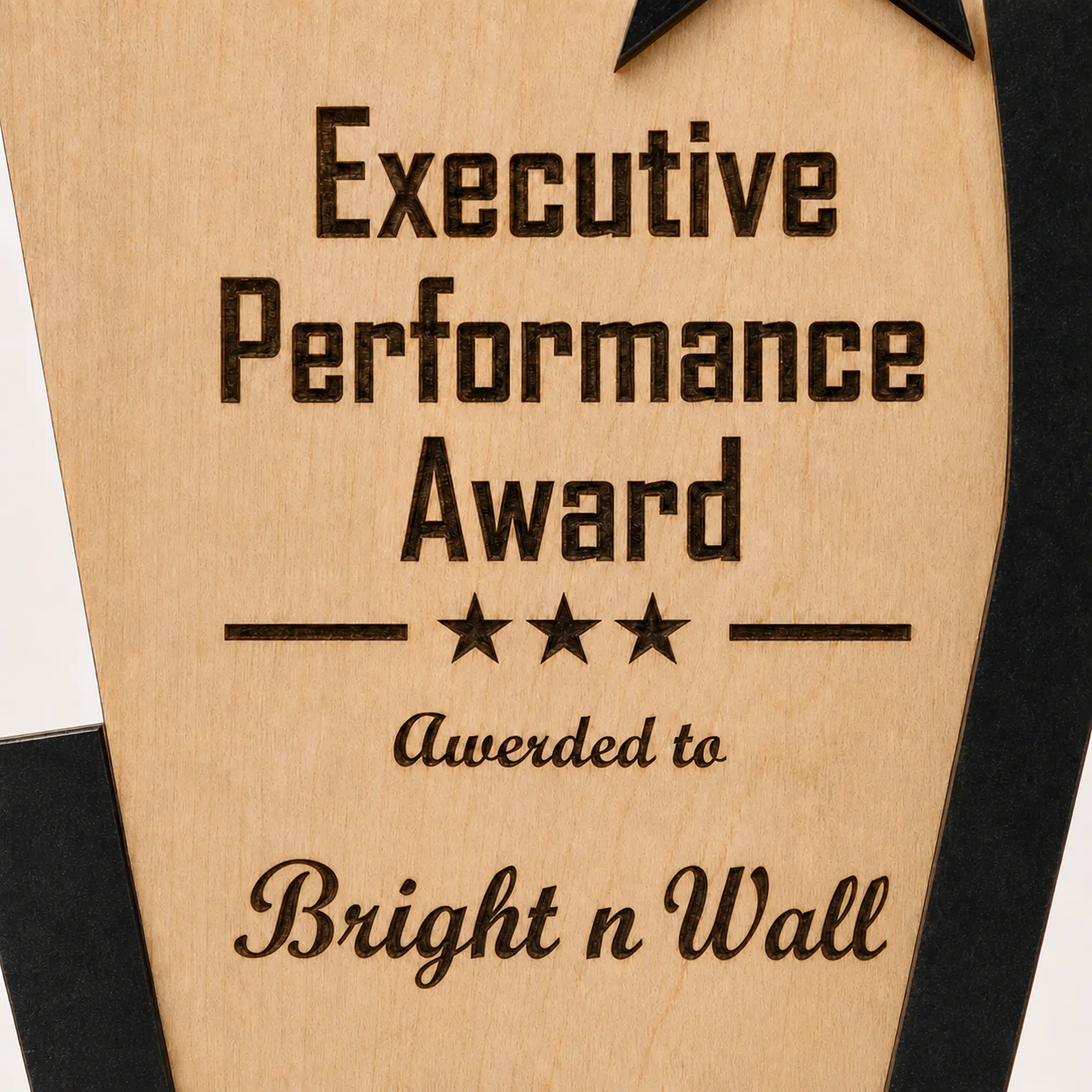 Close-up of laser-engraved Bright n Wall name on personalized MDF performance award