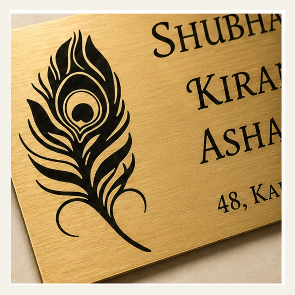 Brushed gold engraving close-up of personalised peacock feather family brushed gold abs name plate with black engraving and 3M tape mounting