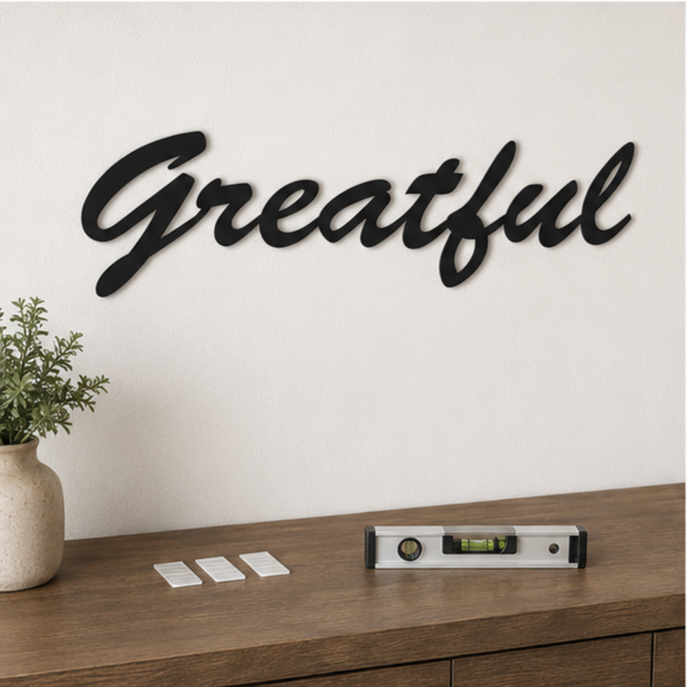 Grateful MDF wall art installation using wall mounting tape and level