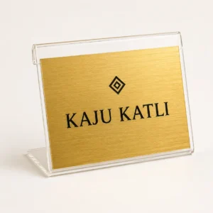 Custom brushed gold mini table label stand with Kaju Katli name and symbol on clear acrylic holder