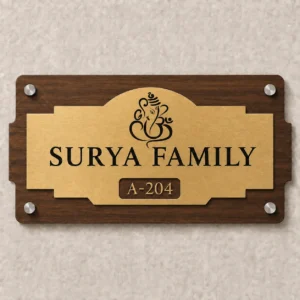 Custom Surya Family Ganapati house name plate with 3 mm CNC-cut walnut ACP base and brushed-gold acrylic – front view