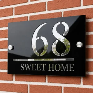 Glossy black and shiny silver acrylic house number plate showing 68 and Sweet Home