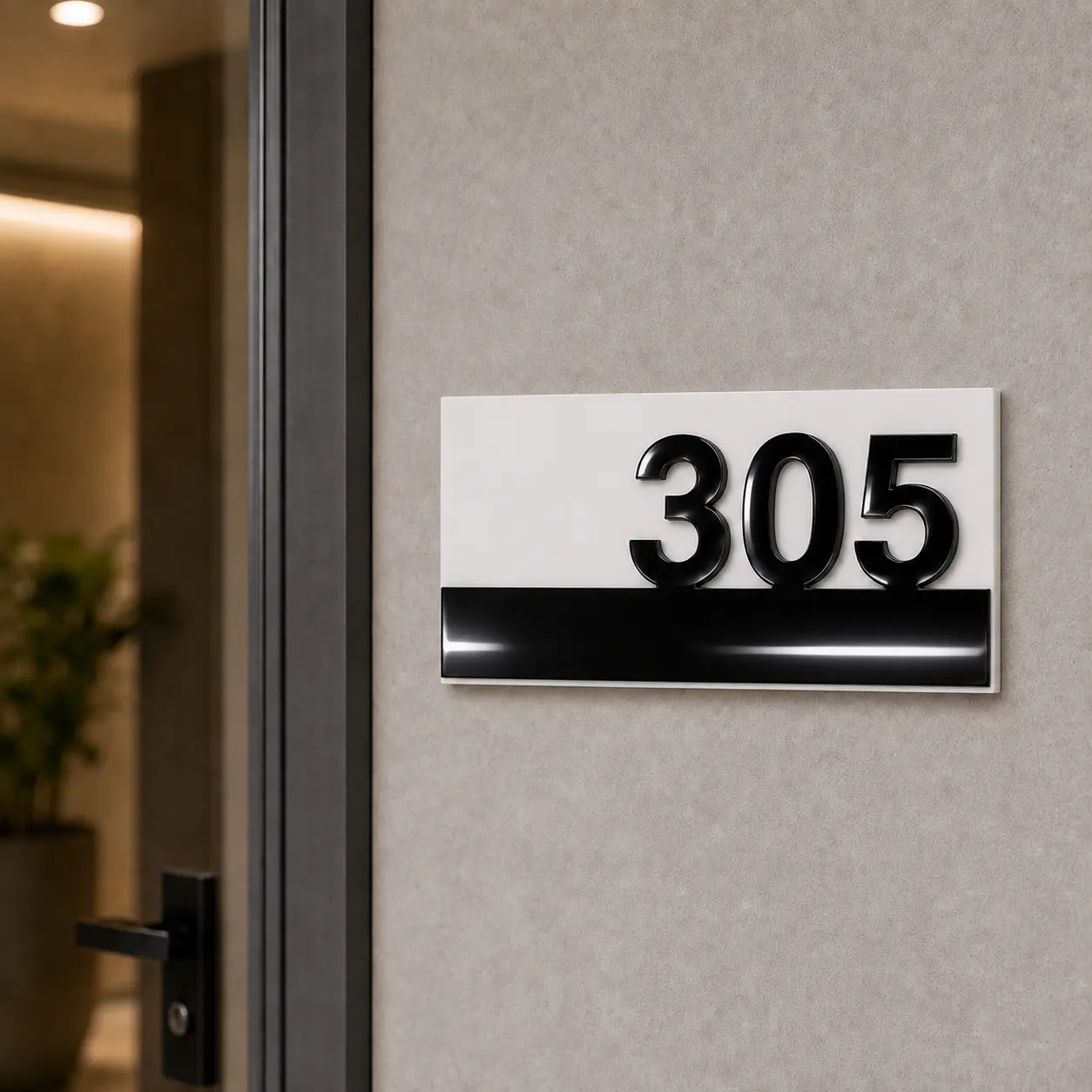 White and black acrylic number plate 305 mounted beside a modern apartment entrance