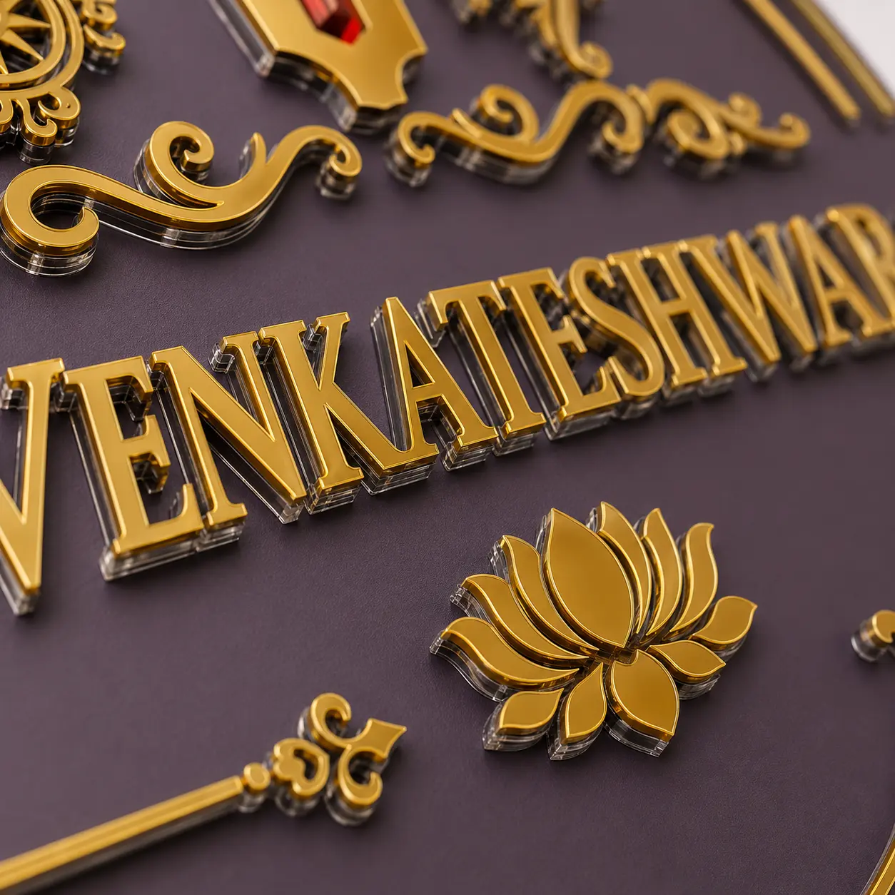 Close-up of clear acrylic and mirror gold floral letters on Venkateshwara name plate