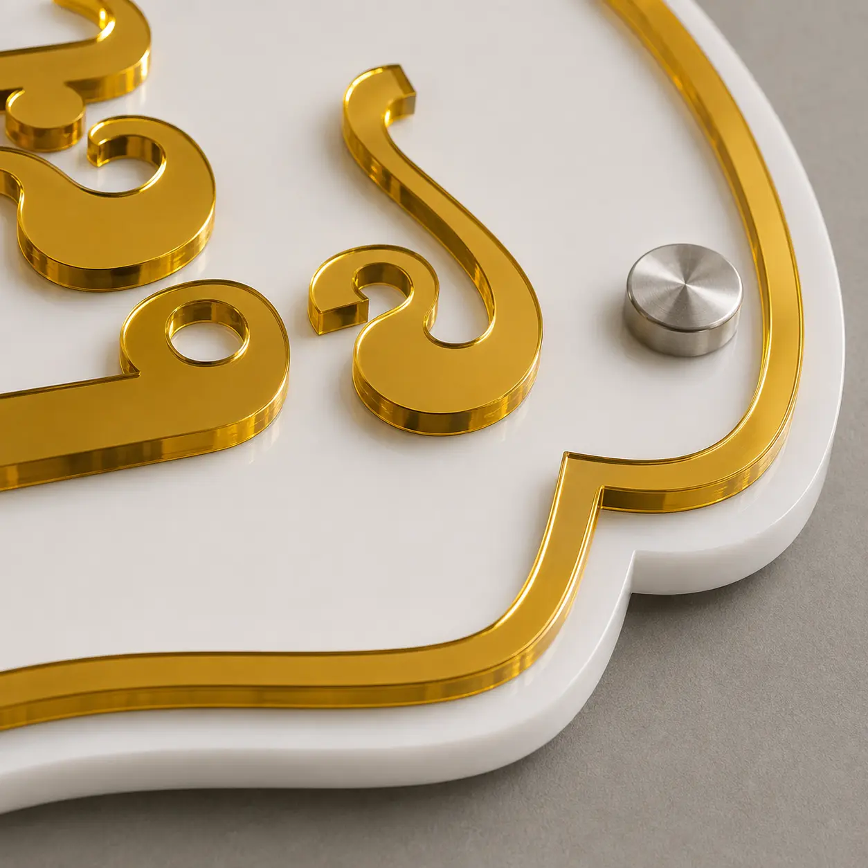 Close-up of 3 mm mirror gold Kannada acrylic letters and Ganesha logo