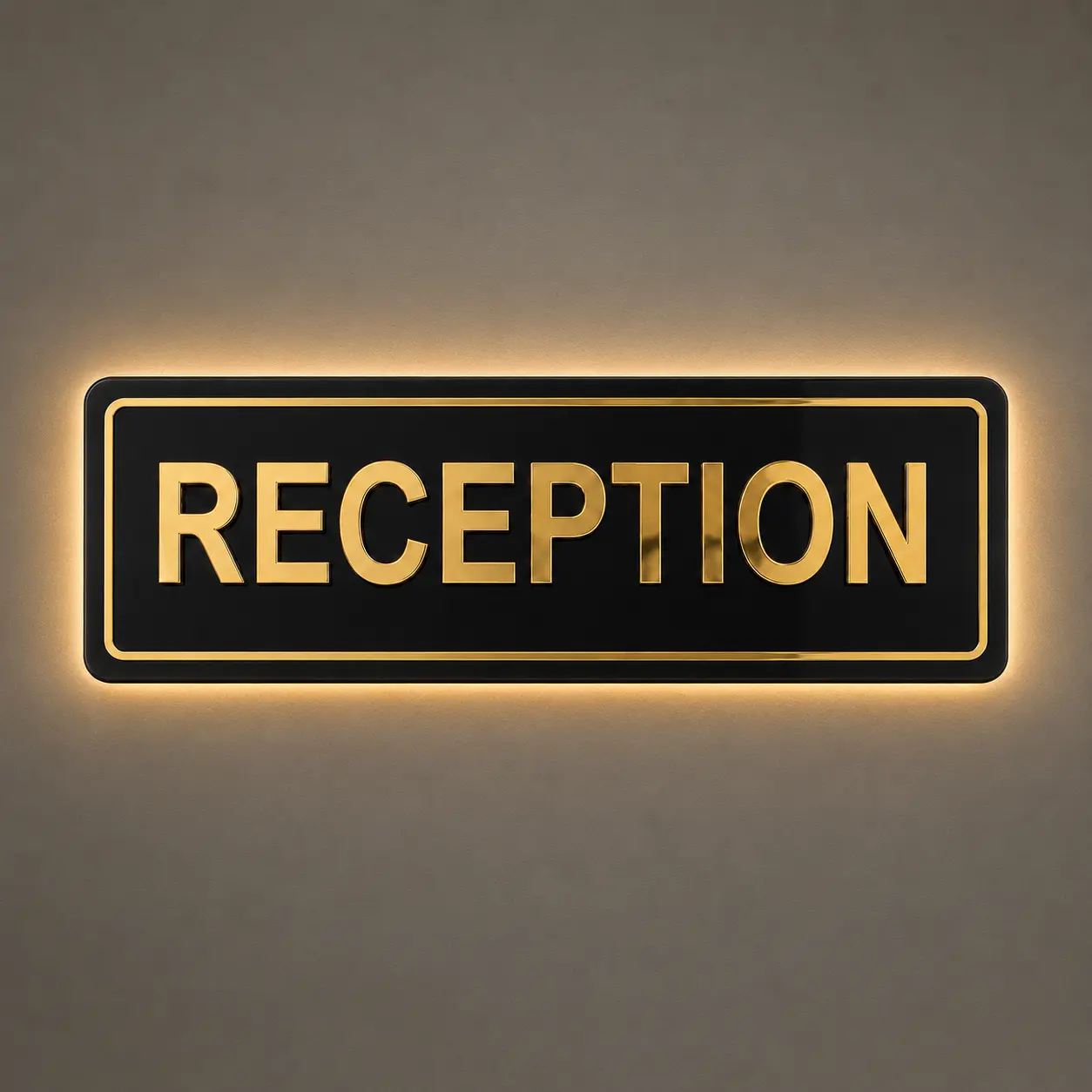 Gold mirror reception sign board with concealed warm LED halo backlighting mounted on a reception wall