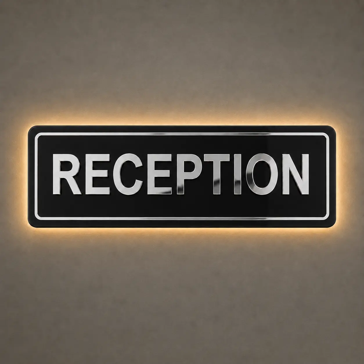 Silver mirror reception sign board with concealed warm LED halo backlighting and rounded glossy black acrylic base