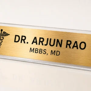 Custom brushed gold desk name plate with clear acrylic stand, doctor symbol and personalised name